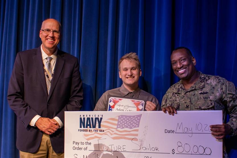 A student is honored for serving in the US Armed Forces after high school